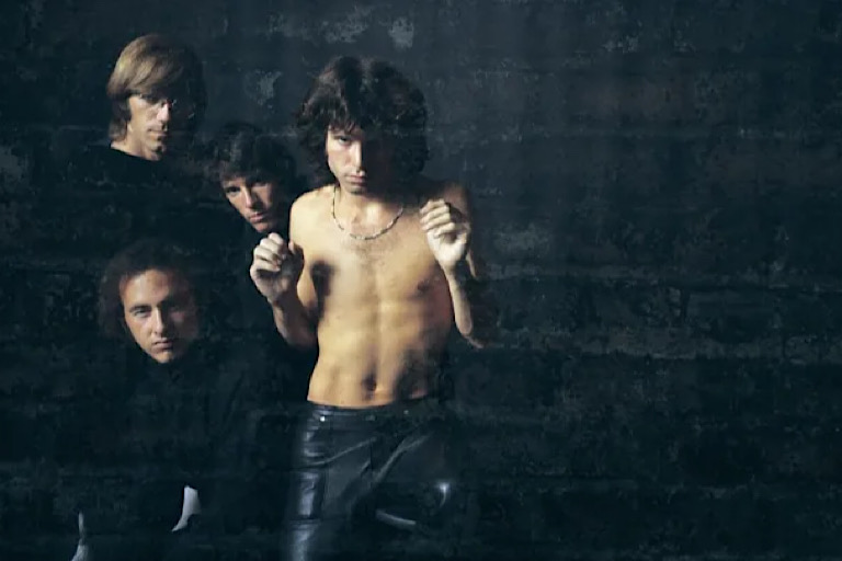 Jim Morrison and his The Doors band mates—Ray Manzarek, John Densmore, and Robby Krieger—pose for their first album cover in 1967. / Mark and Colleen Hayward/Hulton Archive/Getty Images