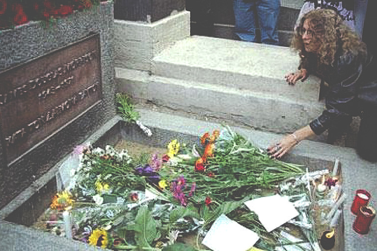 A fan leaves flowers at the grave of US rock star Jim Morrisson in Paris CREDIT: Photo: REUTERS